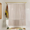 Sun grid shower curtain in honey in bathroom