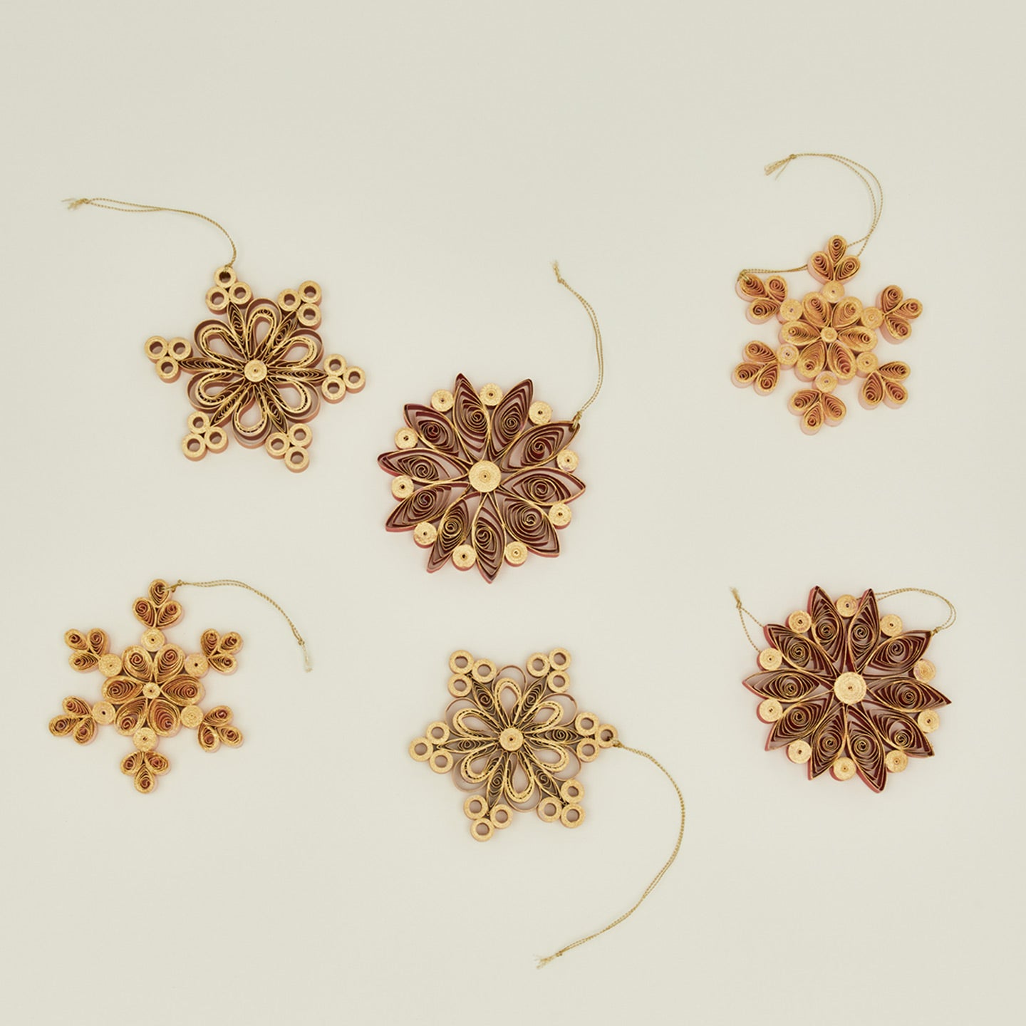 Quilled snowflake ornaments in warm