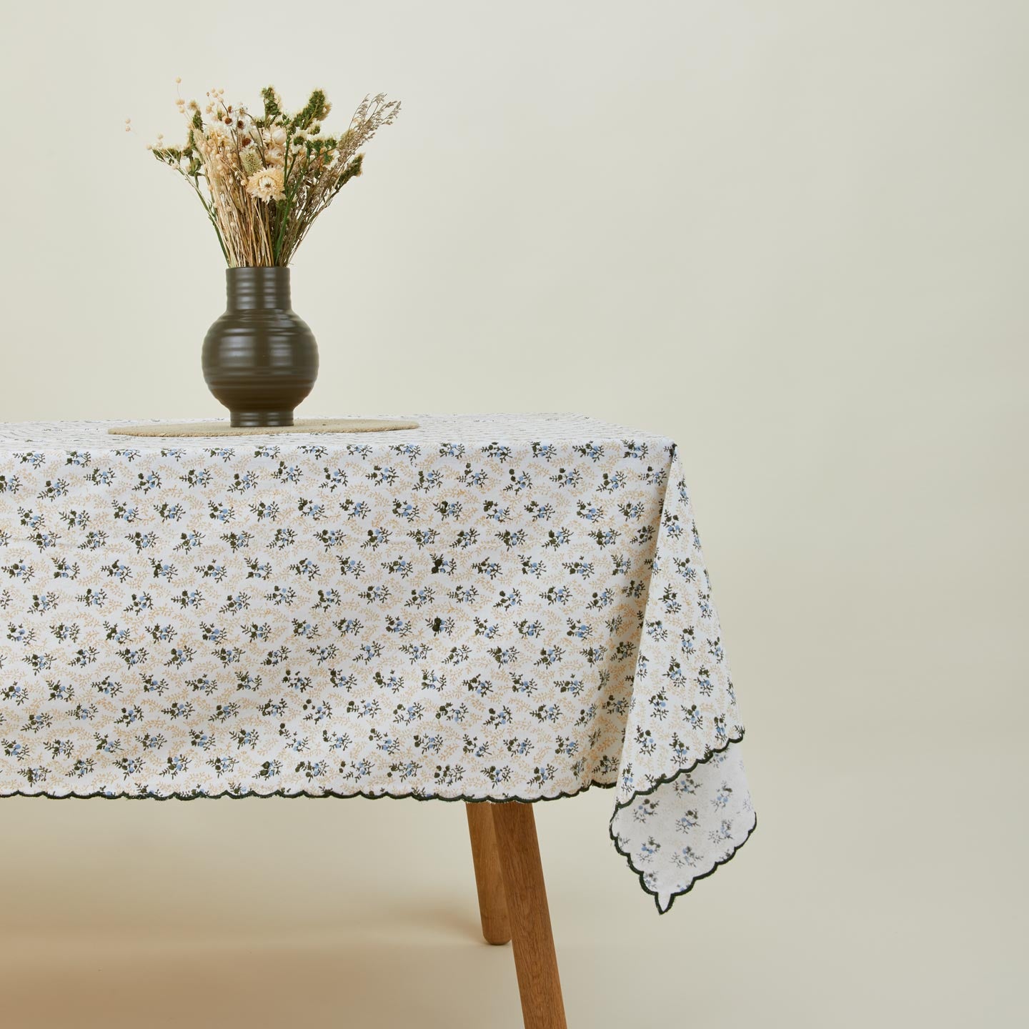Little flowers rectangular tablecloth in green on table with vase and flowers.