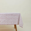 Little flowers rectangular tablecloth in maroon on table.