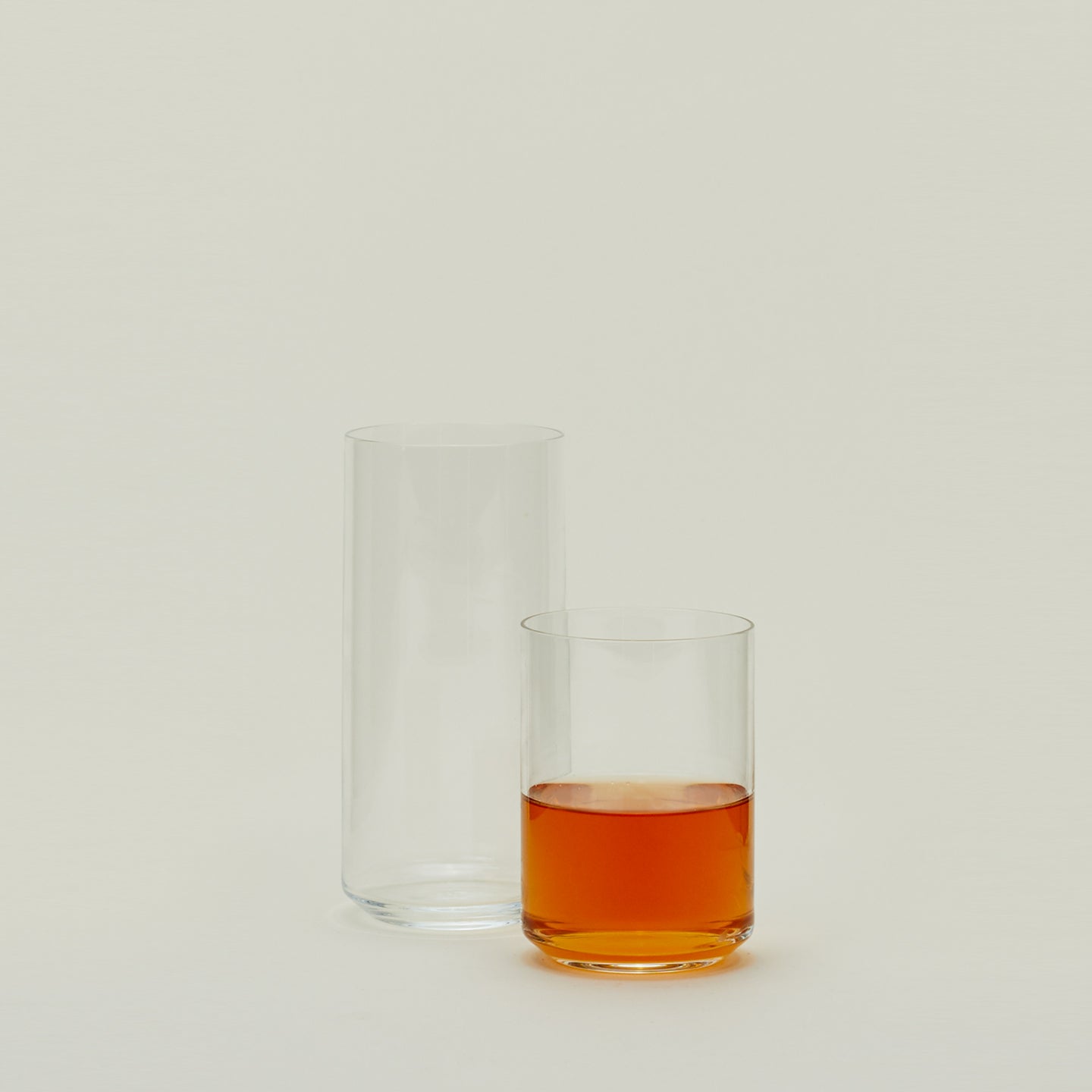 Two clear Simple Glasses in various sizes, one filled with tea.