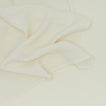 Detailed view of simple linen napkin in ivory