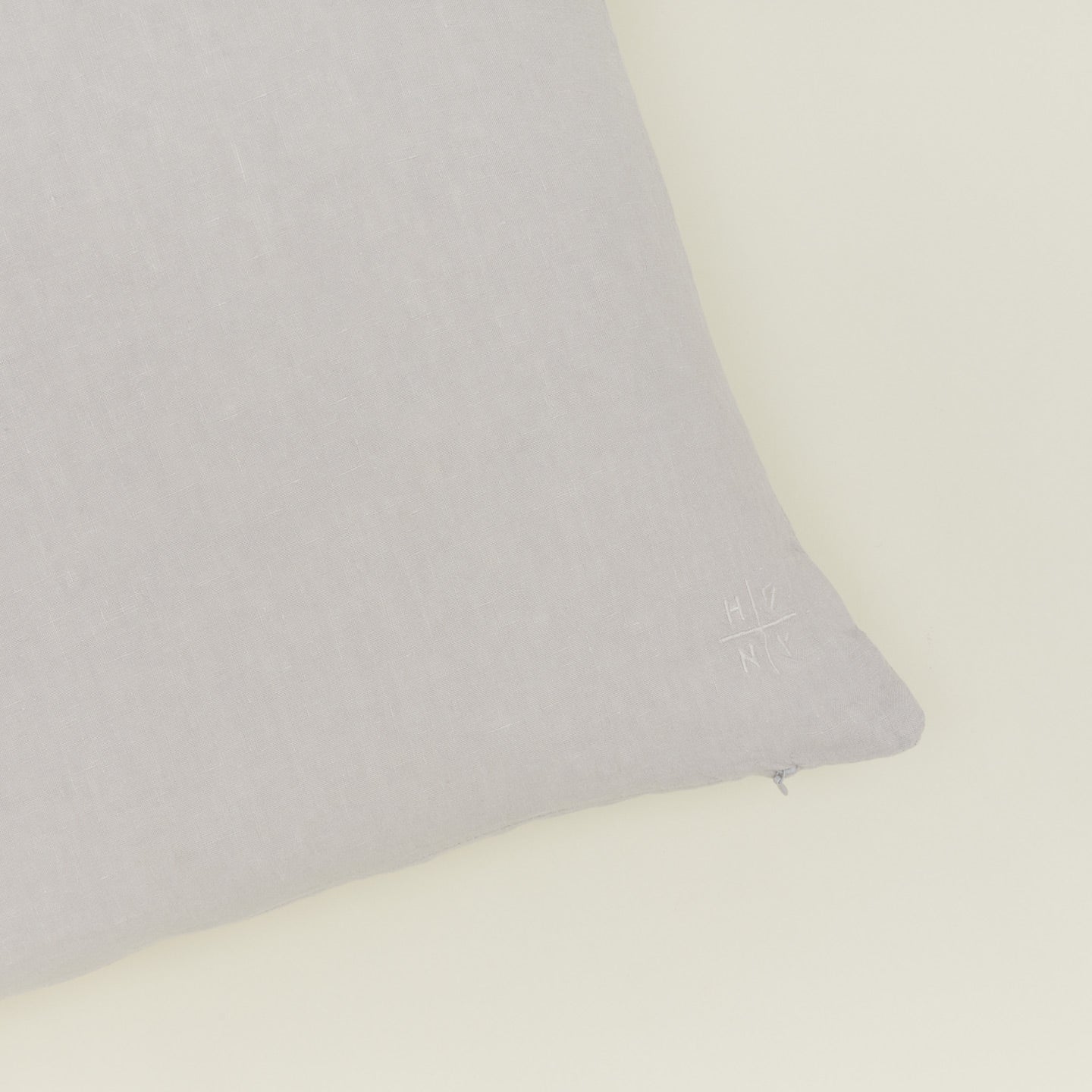 Close up of view of simple linen pillow in light grey