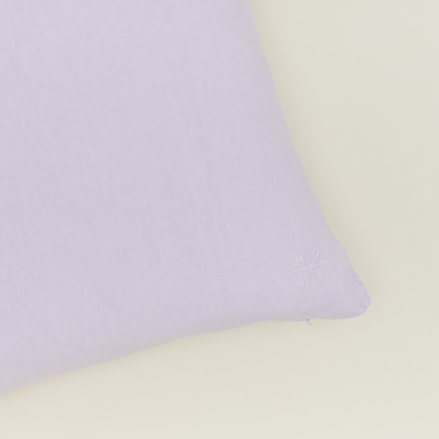 Close up view of simple linen pillow in lilac