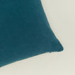 Close up view of simple linen pillow in peacock