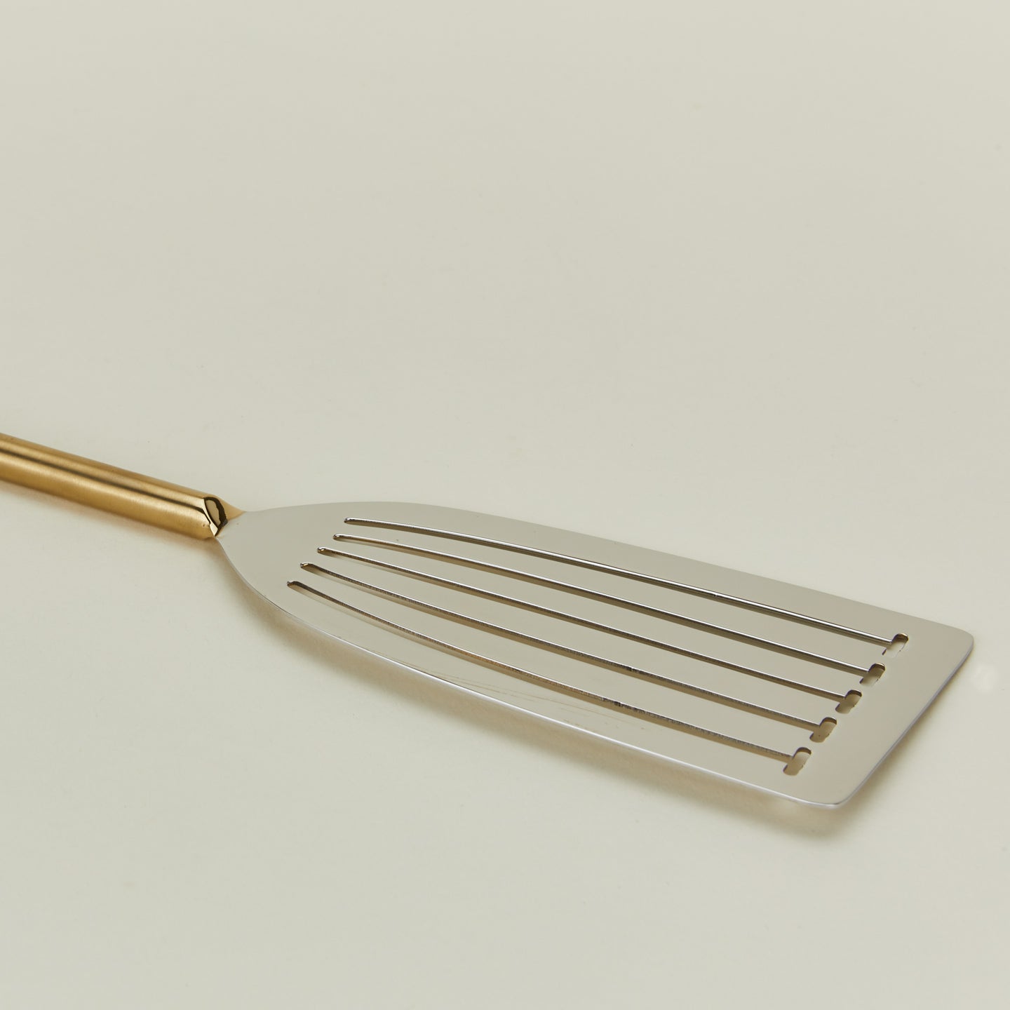 Close up view of Simple metal fish spatula in brass