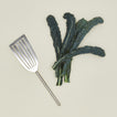 Simple metal fish spatula in silver with vegetables