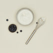 Simple metal whisk in silver with yogurt and blueberries