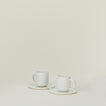 Simple porcelain espresso mugs with saucers in white