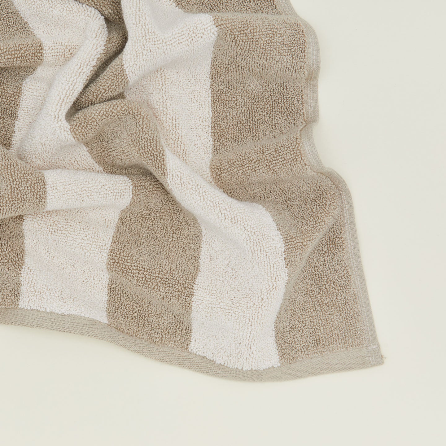 Close up of Simple Striped Terry Bath Mat in ivory and flax.