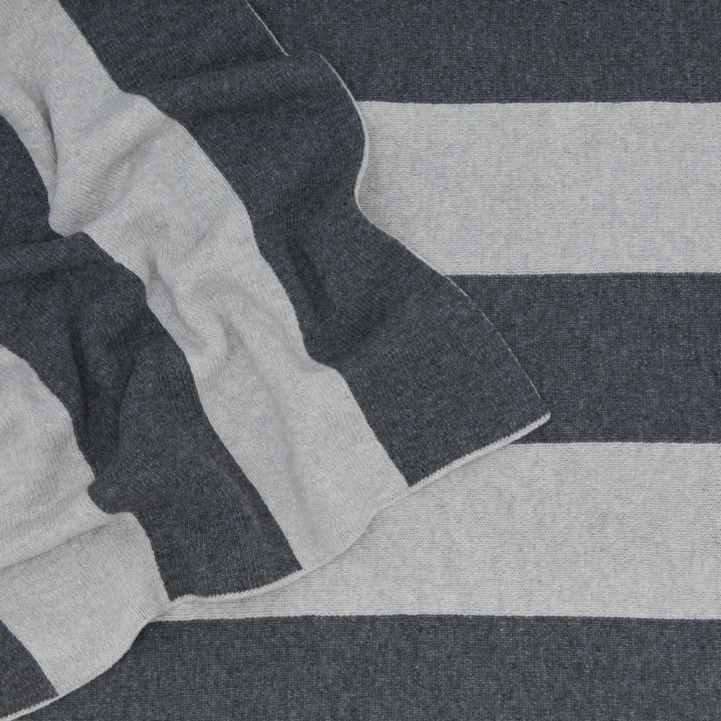 Striped throw in light grey and dark grey close up 