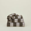 A stack of striped olive and sage terry towels in various sizes.