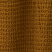 Close up view of simple waffle shower curtain in bronze