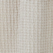 Close up view of simple waffle shower curtain in light grey