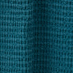 Close up view of simple waffle shower curtain in peacock