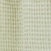 Close up view of simple waffle shower curtain in sage.
