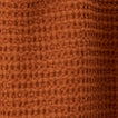 Close up view of simple waffle shower curtain in terracotta