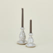 Large and small splatterware candlesticks in white and grey with candles