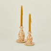 Large and small splatterware candlestick holders in ivory and bronze with candles