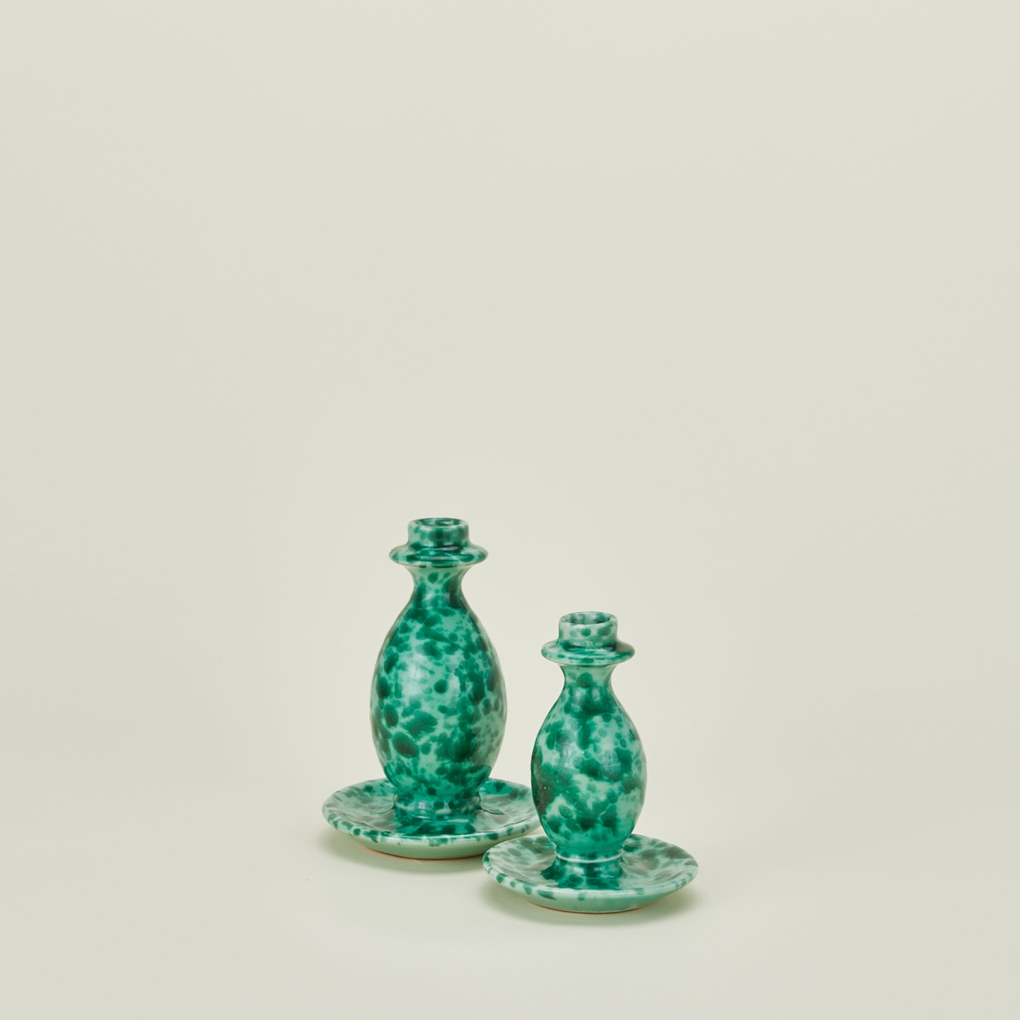 Large and small splatterware candlesticks in sage and green