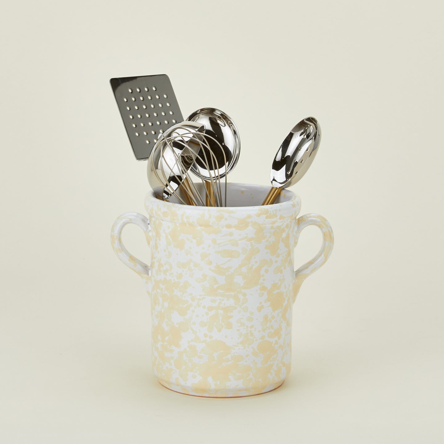 Splatterware crock in white and ivory with kitchen utensils