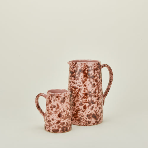 Large and small splatterware pitchers in blush and terracotta