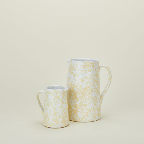 Large and small splatterware pitchers in ivory and white