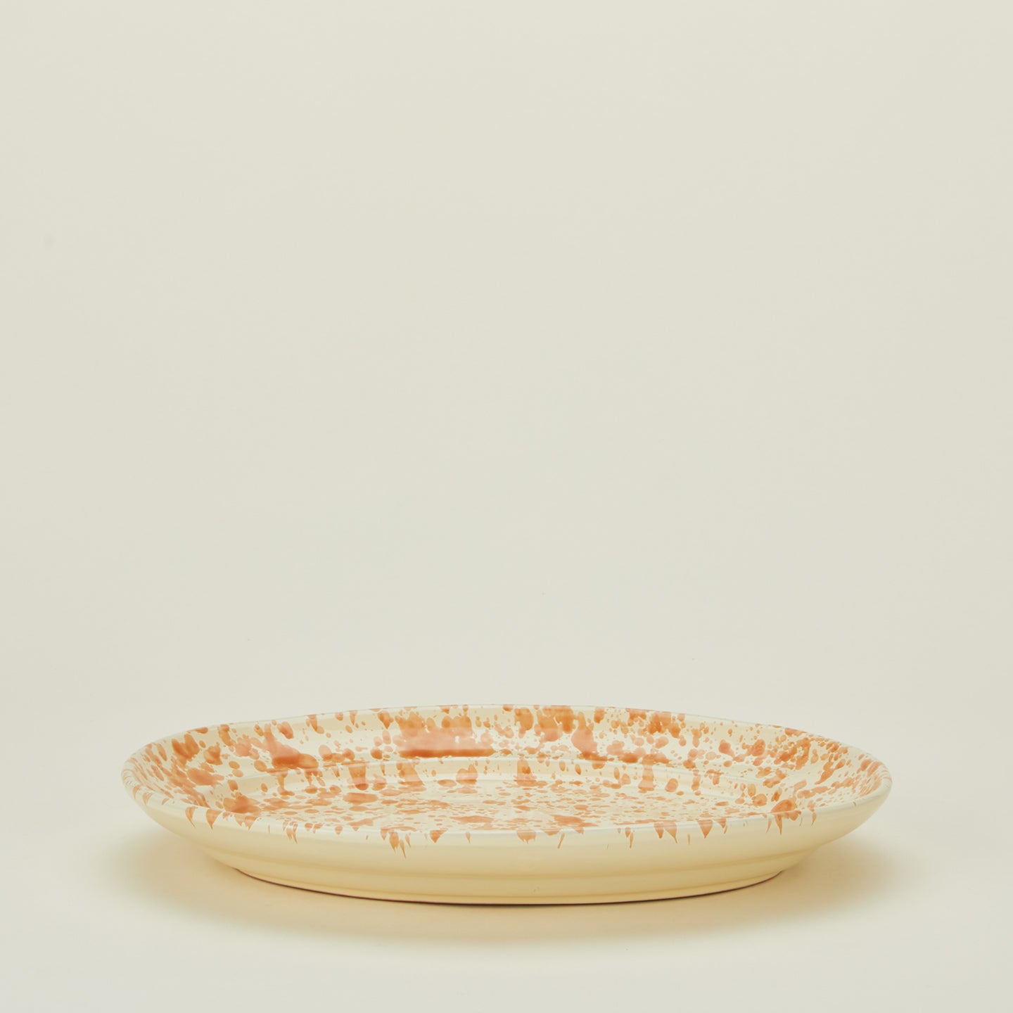 Splatterware serving platter in ivory and bronze