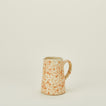 Small splatterware pitcher in ivory and bronze