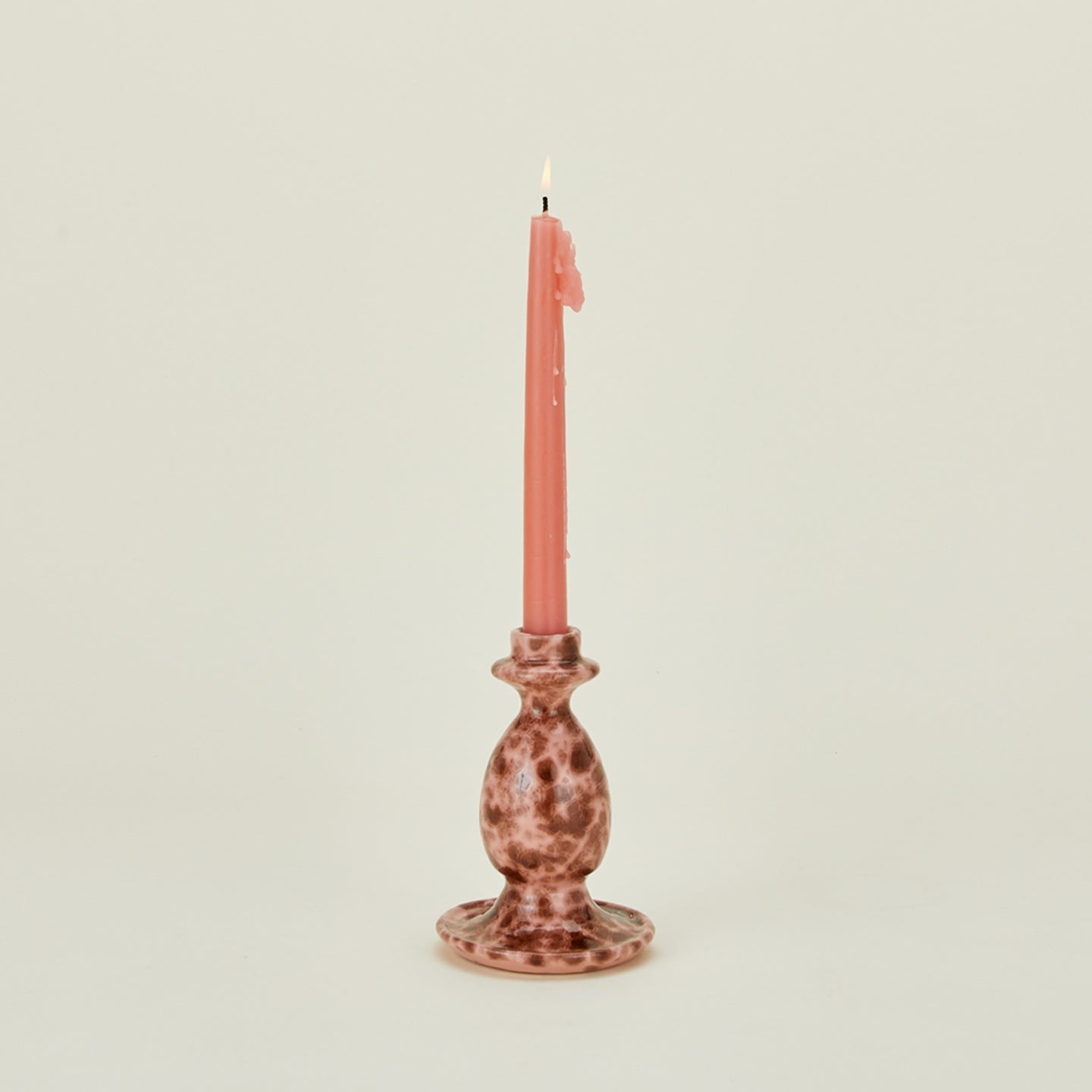Small splatterware candlestick holder in blush and terracotta with candle