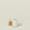 Small splatterware canister in white and ivory with candy