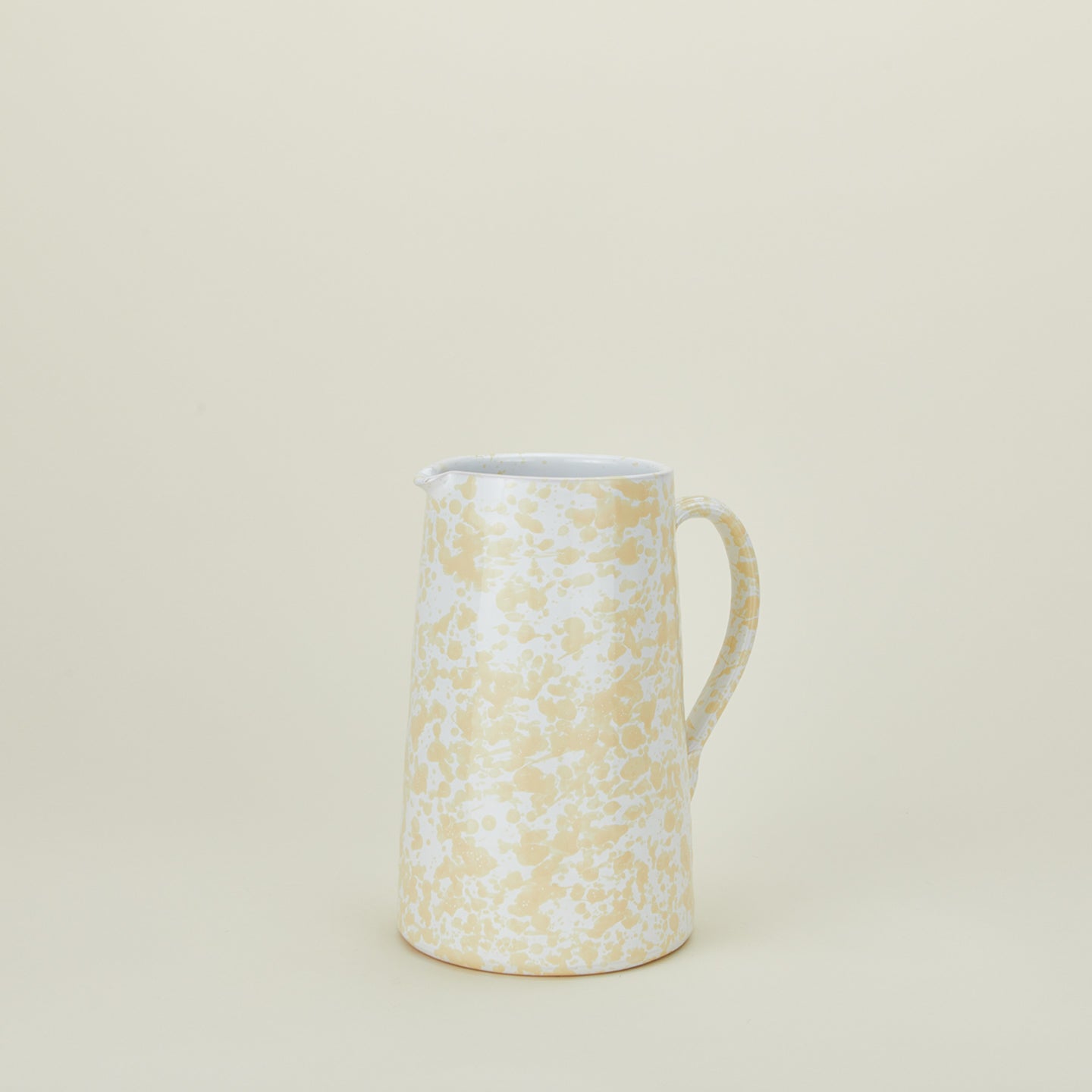Large splatterware pitcher in white and ivory
