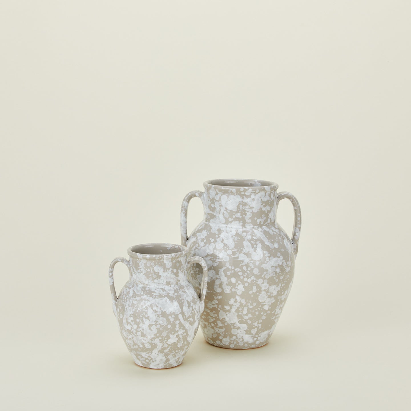 Large and small splatterware vases in grey and white
