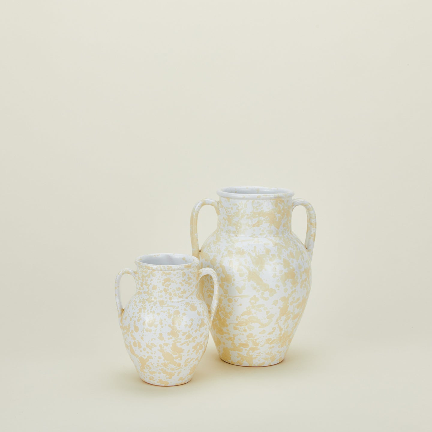 Large and small splatterware vases in ivory and white 