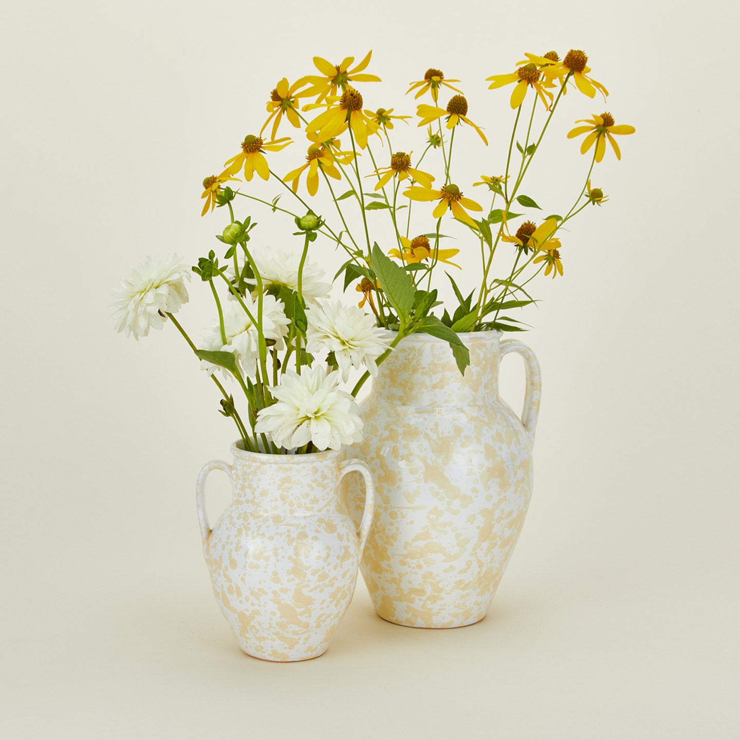 Large and small splatterware vases in ivory and white with florals