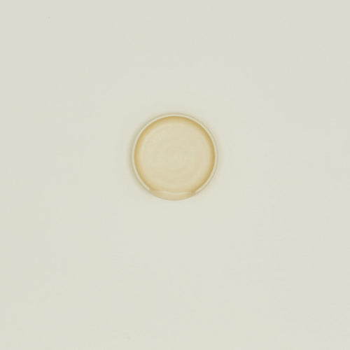An overhead of a butter stoneware spoon rest.