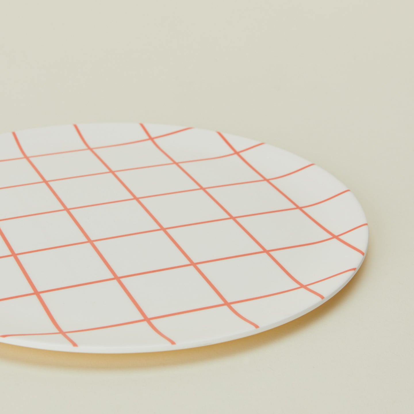 Close up view of Bamboo Melamine Dinner Plate in Red Grid