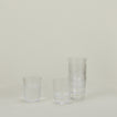 Set of 6 Veneziano Tumblers in Clear, stacked, with water.