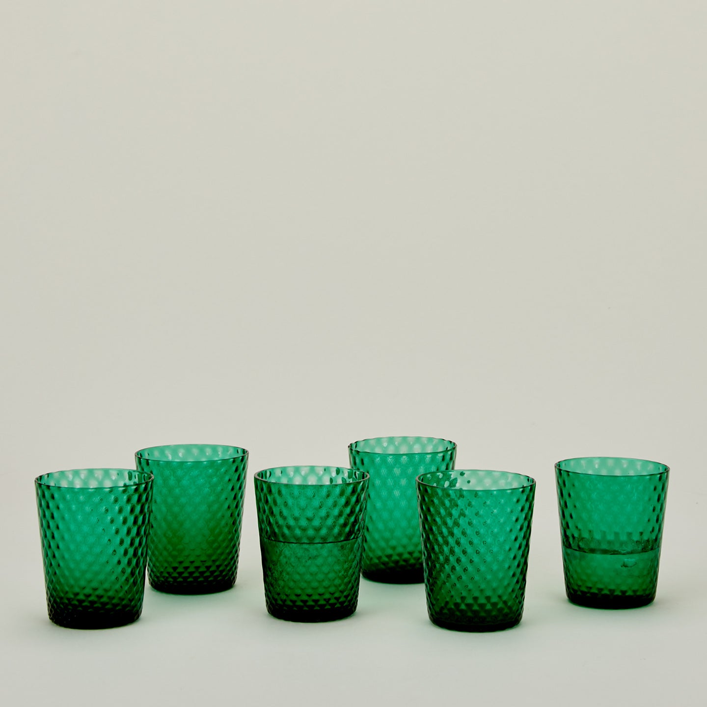 Set of 6 Veneziano Tumblers in Green, with water.