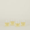 Four clear Boreal Tumblers in Medium size filled with white wine.