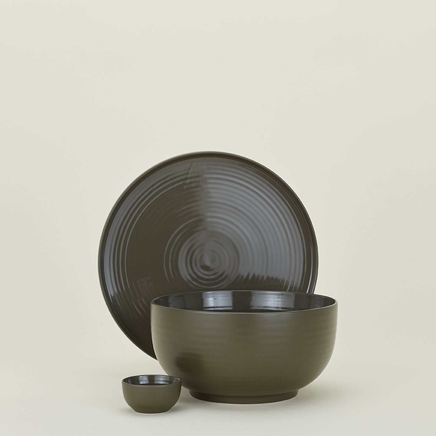 Group of Essential serving pieces in Olive including bowl, platter and extra small bowl.