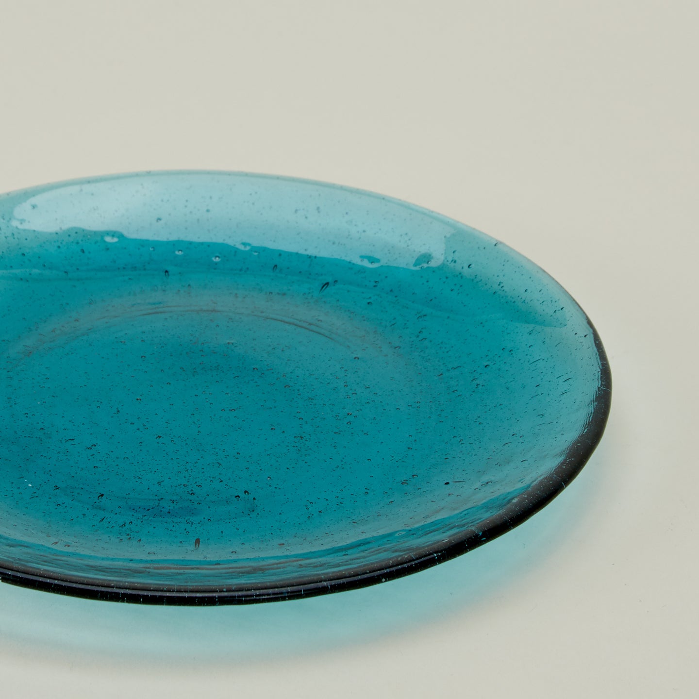 Close up of Glass Dinner Plate in Peacock.
